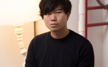 Headshot of Chan Tze Woon sat in front of a lamp.