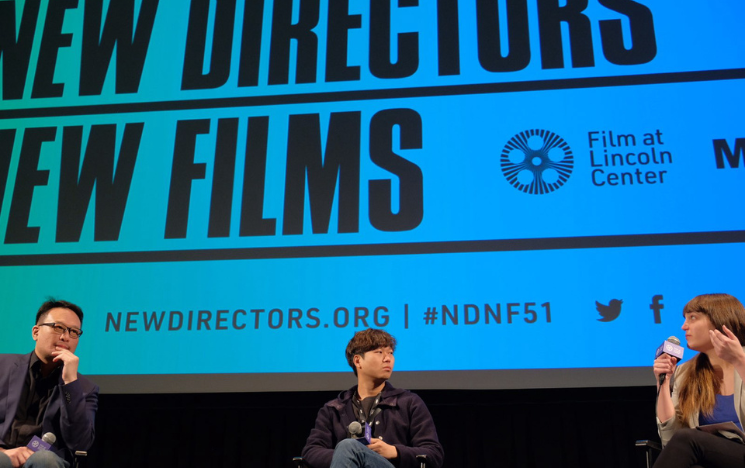 Chan Tze Woon sat on a panel in front of a screen that reads New Directors, New Films.