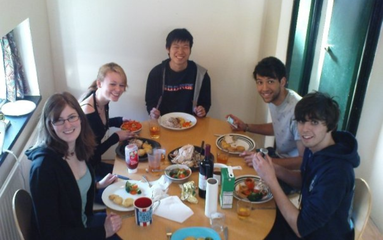 Chan Tze Woon sat around a table enjoying a Sunday Roast with friends while at the University of Sussex.