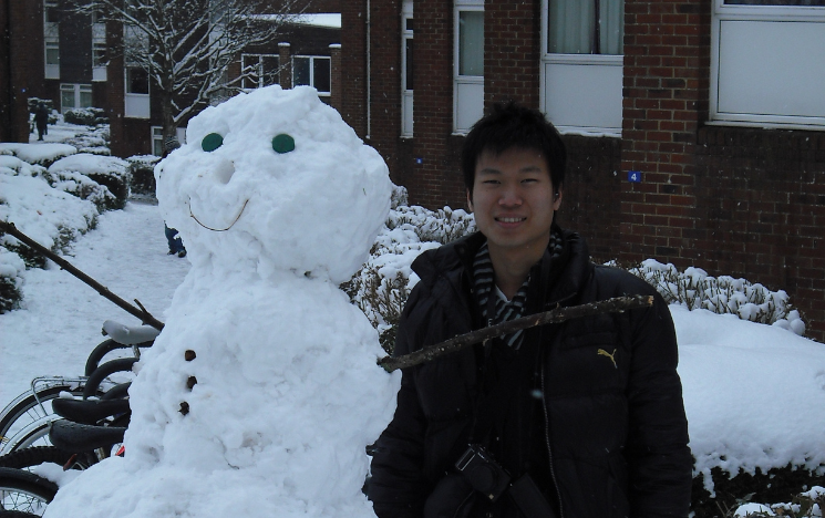 Chan Tze Woon stood to the right of a snowperson on campus at the University of Sussex.