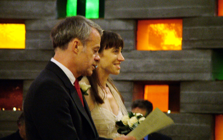 A close up of Alexandra Loske and Jeremy Page during their wedding in the Meeting House. Photographer: Strat Mastoris