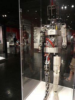 Human shaped robot with it's wiring exposed in a glass case. Photo Credit Ioannis Papadakis.