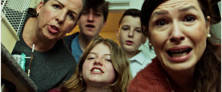 A still from 'Haven' - taken from the floor looking up at 5 people (2 women, 1 girl, 2 boys), they all look concerned.