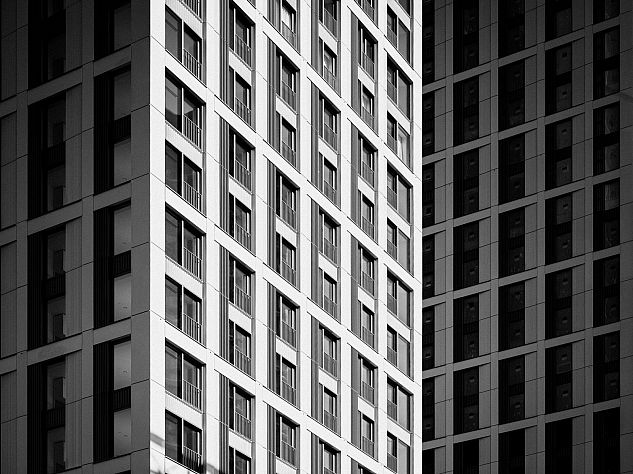 A modern high-rise in London photographed in black and white.