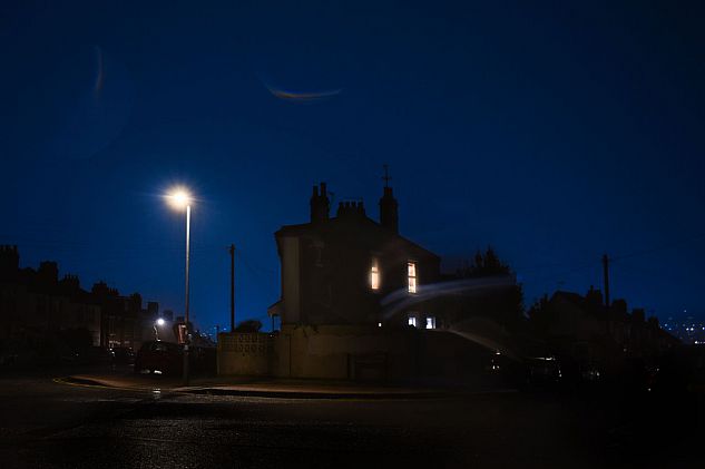 A house by an empty road at twilight