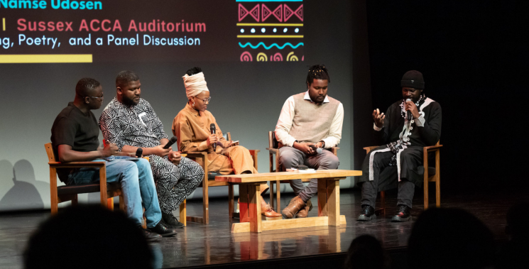 A group of people sat on stage at the Attenborough Centre, engaging in a discussion.