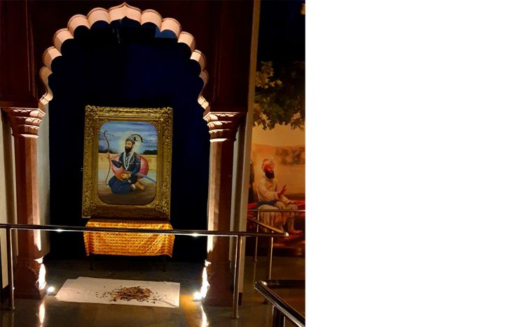 Donations by devotees in front of Guru Gobind Singh's portrait in the museum