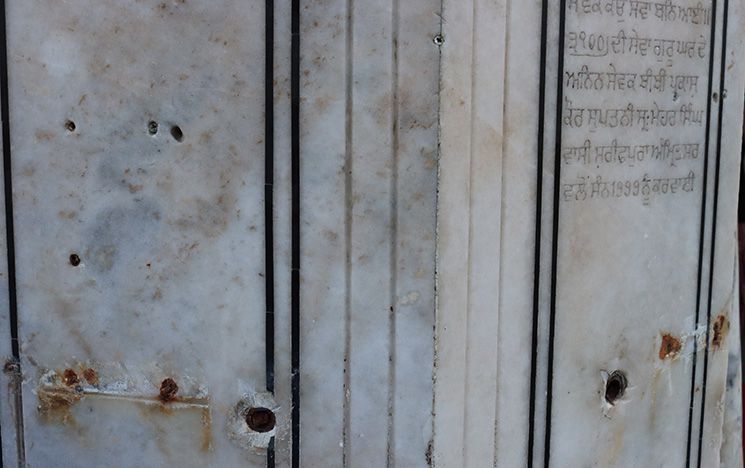 Bullet holes on marble pillars from Operation Bluestar involving the (para)military storming of the Harmandir Sahib in 1984
