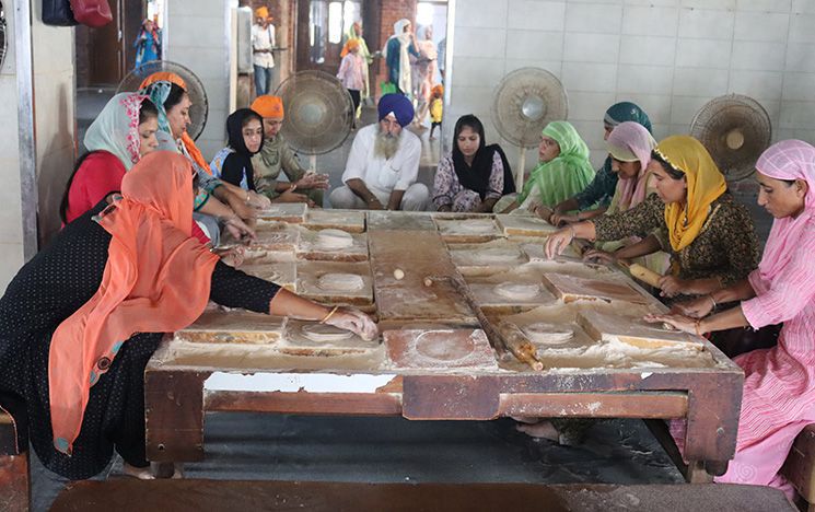 Doing seva (selfless service) by making chapatis for the free meals (langar)