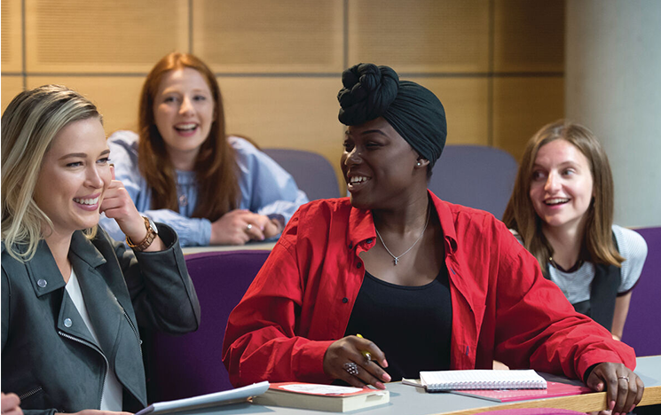 Students engaging with each other in a lecture theatre