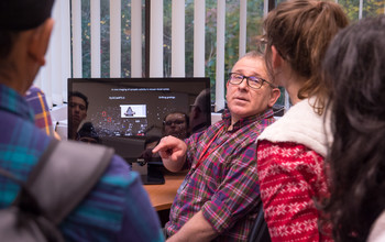 A researcher talking to students
