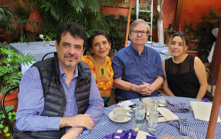 Four alumni sitting at a table in a restaurant in Mexico