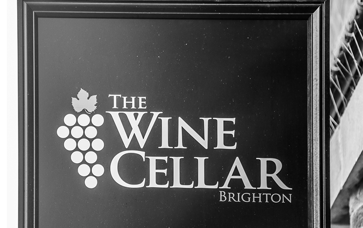 A black and white sign for The Wine Cellar in Brighton