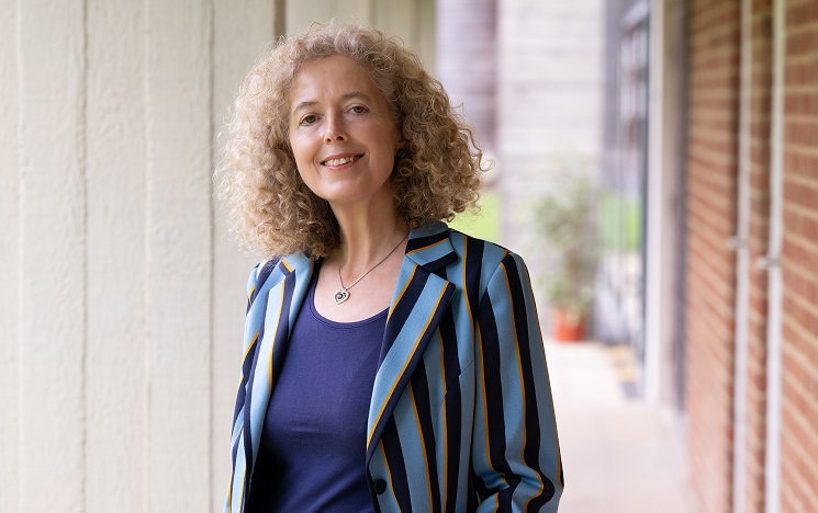 Professor Michelle LeFevre standing outside a red brick building