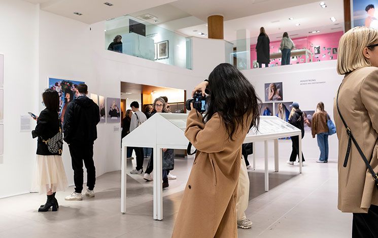 A photo of students browsing a London art gallery