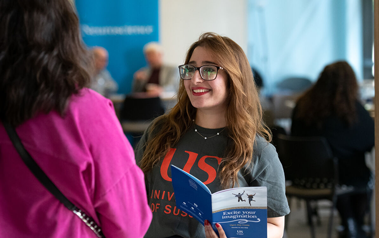  A student ambassador speaking to an open day visitor