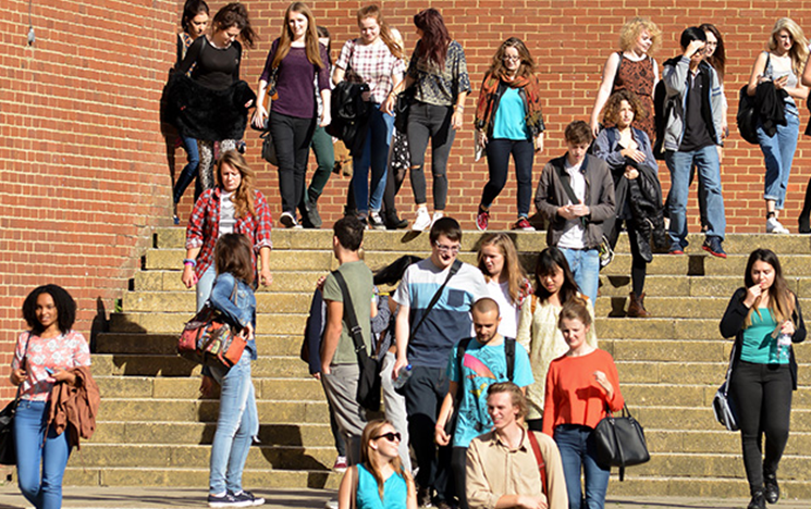 School students walking down the steps on campus