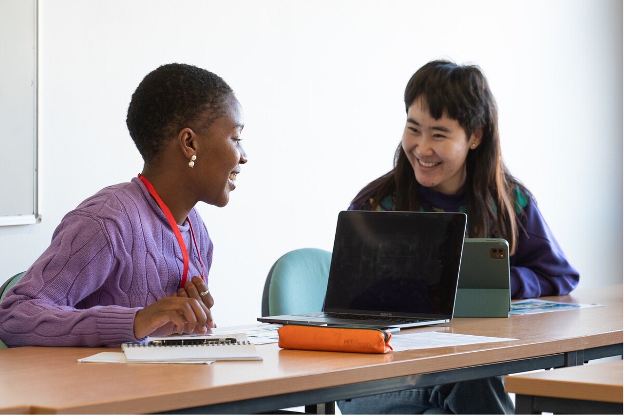 
A photo of two students working together at a desk