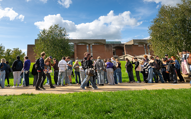 A large group of students in front of the library.