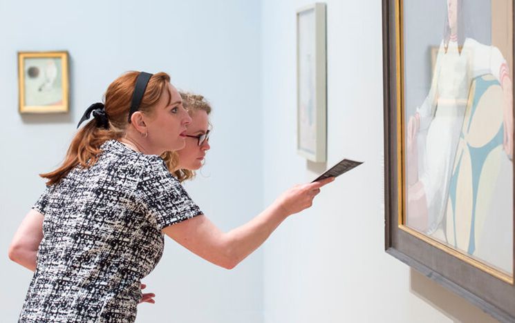 Women looking at a painting in an art gallery