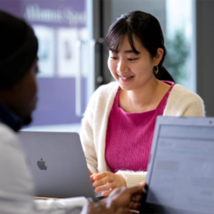 Student smiling on laptop